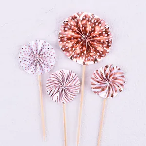 Decorative set of 4 rose gold and white paper fan cake toppers for birthday party.