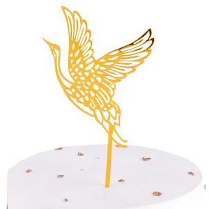 Elegant gold acrylic crane bird cake topper for traditional birthday baking decorations