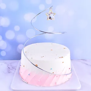 Detailed view of elegant spiral metal cake topper featuring a sparkling crystal star pendant