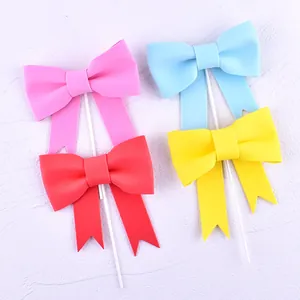 Colorful bow-tie cake toppers in pink blue red yellow for birthday party decoration
