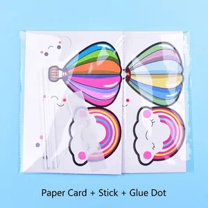 Cute rainbow and hot air balloon cake topper set with smiley clouds for birthdays