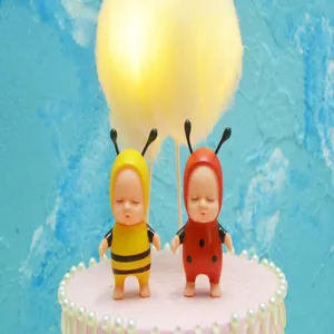 Close-up of glowing cotton cloud cake topper with cute bee and ladybug figurines