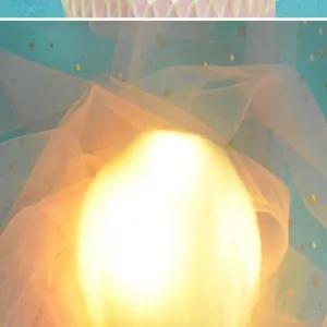 Close-up of glowing cotton cloud cake topper with warm yellow light