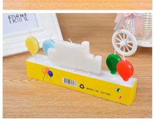 Detailed view of colorful balloon-shaped birthday candles and a large white candle.
