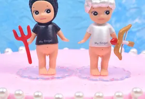 Close-up of transparent plastic cake topper bases holding decorative figurines