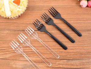 Detailed view of disposable black and transparent plastic fruit forks for desserts