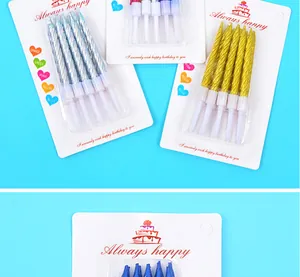 Close-up of metallic gold and silver threaded birthday candles in retail packaging for cakes