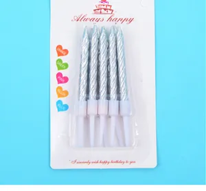 Close-up of silver spiral birthday candles in packaging for party cake decoration