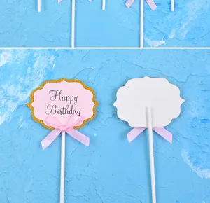Detailed view showing front and back of pink DIY paper cake topper with Happy Birthday text