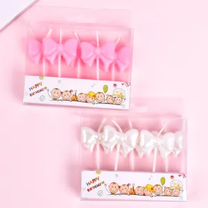 Pink and white bowknot birthday candles for cake decoration and party supplies