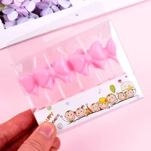 Set of 5 pink bow-shaped birthday candles in cute decorative packaging for parties