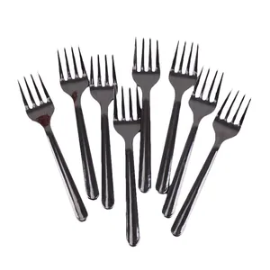 Eight disposable black plastic fruit forks arranged in a fan shape on a white background