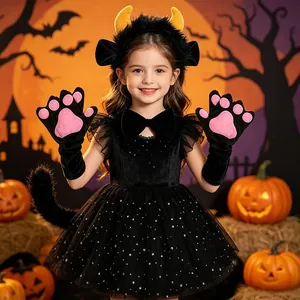 Detail view of girl in black Halloween costume with ox horn headband and pink paw gloves