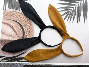 Close-up view of black and mustard yellow plush rabbit ear headbands for cosplay costumes