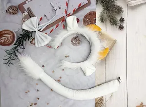 Detailed flat lay of white furry animal costume set with cow ear headband and tail