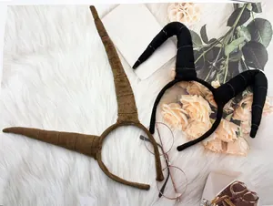 Detailed view of Halloween antelope and bull horn headbands on plush white rug