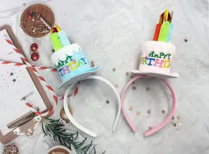 Two colorful birthday cake headbands in blue and pink for festive party celebrations