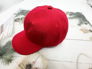 Detailed view of a vibrant red baseball cap styled with festive Christmas decorations.