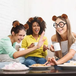 Lifestyle detail showing friends wearing cute plush bear ear headbands at a social party