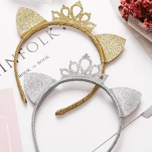 Close-up of glitter cat ear crown headbands in gold and silver for birthday parties