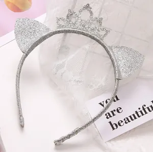 Detail of silver glitter cat ear headband with a mini crown for party birthday celebrations.