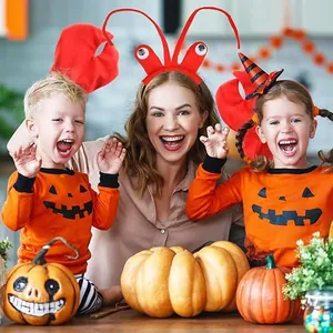 Red lobster headband and claw gloves worn by family in festive Halloween setting