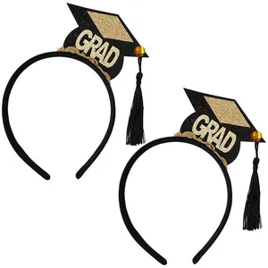 Close-up of graduation mortarboard headbands with gold glitter accents and black tassels