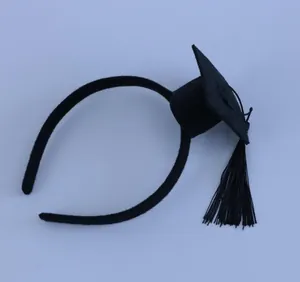 Close-up detail of a black mini graduation cap headband with fine tassel ornament