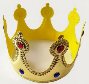 Detail view of a golden party crown with sparkling red and blue gem decorations