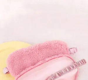 Detail of plush rabbit fur and silk sleep mask showing soft pink textures