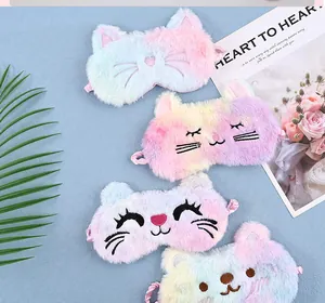Macro view of plush rainbow unicorn and animal sleep masks for travel and rest