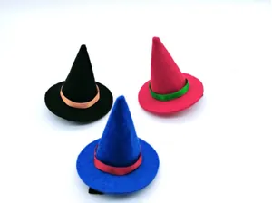 A set of three miniature pointed decorative hats in black, pink, and blue with satin ribbons.