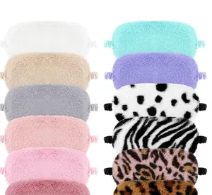 Detailed view of various plush sleep eye masks in solid colors and animal prints