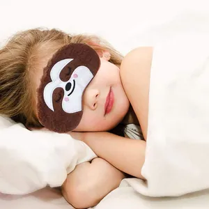 Cute sloth plush sleep mask for kids sleeping comfortably in soft white bedding decor
