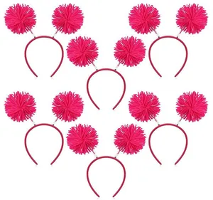 Macro view of six vibrant pink handmade wool pom-pom headbands for festive events.
