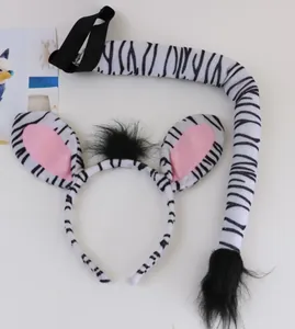 Detailed macro view of plush zebra ear headband and matching striped tail costume accessory