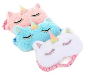 Detail view of plush unicorn sleep masks in pink blue and white featuring glitter eyelashes