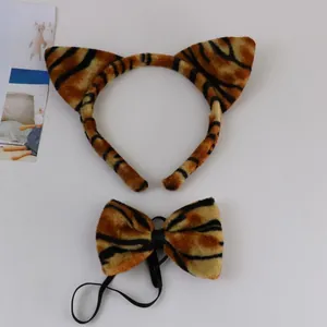 Detail view of plush tiger-ear headband and matching bowtie costume accessory set.