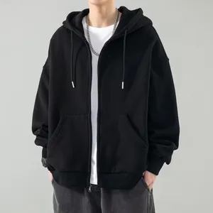 Close-up view of a minimalist black zip-up hoodie featuring warm fleece lining