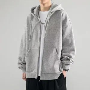 Detailed view of a stylish gray zip-up hoodie featuring a drawstring hood and large front pockets