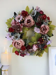 Close-up of a vintage peony wreath with lush artificial flowers for home wall decor.