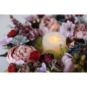 Detailed macro view of vintage pink peony wreath with warm ambient candle lighting