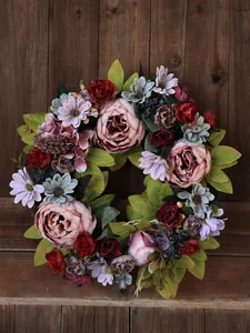 Macro detail of a vintage peony wreath with dark berries on a rustic wooden background.