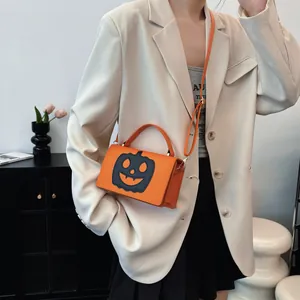 Orange Halloween pumpkin crossbody bag for women with black face cutout design