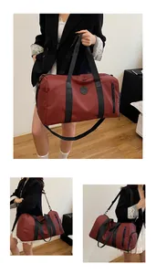 Large red duffle bag for travel and gym shown in multiple hand and shoulder carry poses
