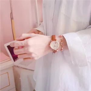 Close-up of a stylish girls' watch with brown leather strap and rose gold case detail