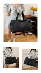 Lifestyle view of a large black travel gym bag being carried by a stylish model