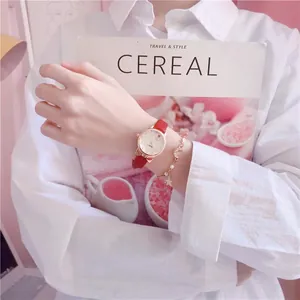 Close-up view of a red leather strap girls' watch with cute cat-ear design details