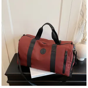 Detail view of a maroon large capacity gym bag with dry-wet separation on a modern shelf.