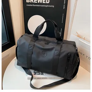 Detailed close-up view of a high-capacity black gym bag with dry-wet separation design.